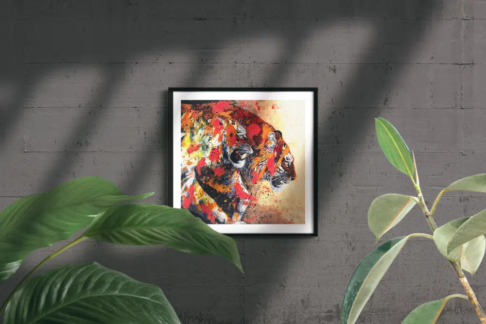 Tiger Friends-framed print mockup in room. A painting of two tigers walking out of darkness into light. The tiger in front snarls. The tiger in back has head lowerd, looking forward with moth slightly open. The tigers are painted over with abstract elements in bright pink, orange and yellow.