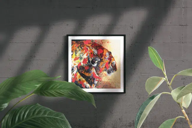 Tiger Friends-framed print mockup in room. A painting of two tigers walking out of darkness into light. The tiger in front snarls. The tiger in back has head lowerd, looking forward with moth slightly open. The tigers are painted over with abstract elements in bright pink, orange and yellow.